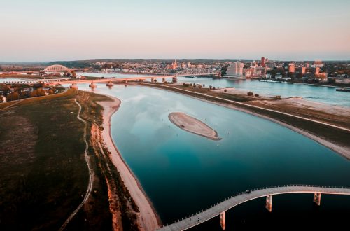 aerial view of city buildings near body of water during daytime