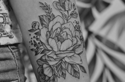 grayscale photo of floral arm tattoo