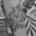 grayscale photo of floral arm tattoo