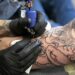 person with tattoo on right arm